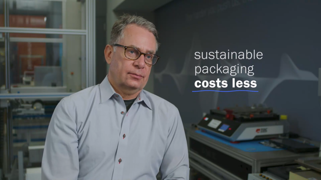 Man speaking in interview with a card reading sustainable packaging costs less.